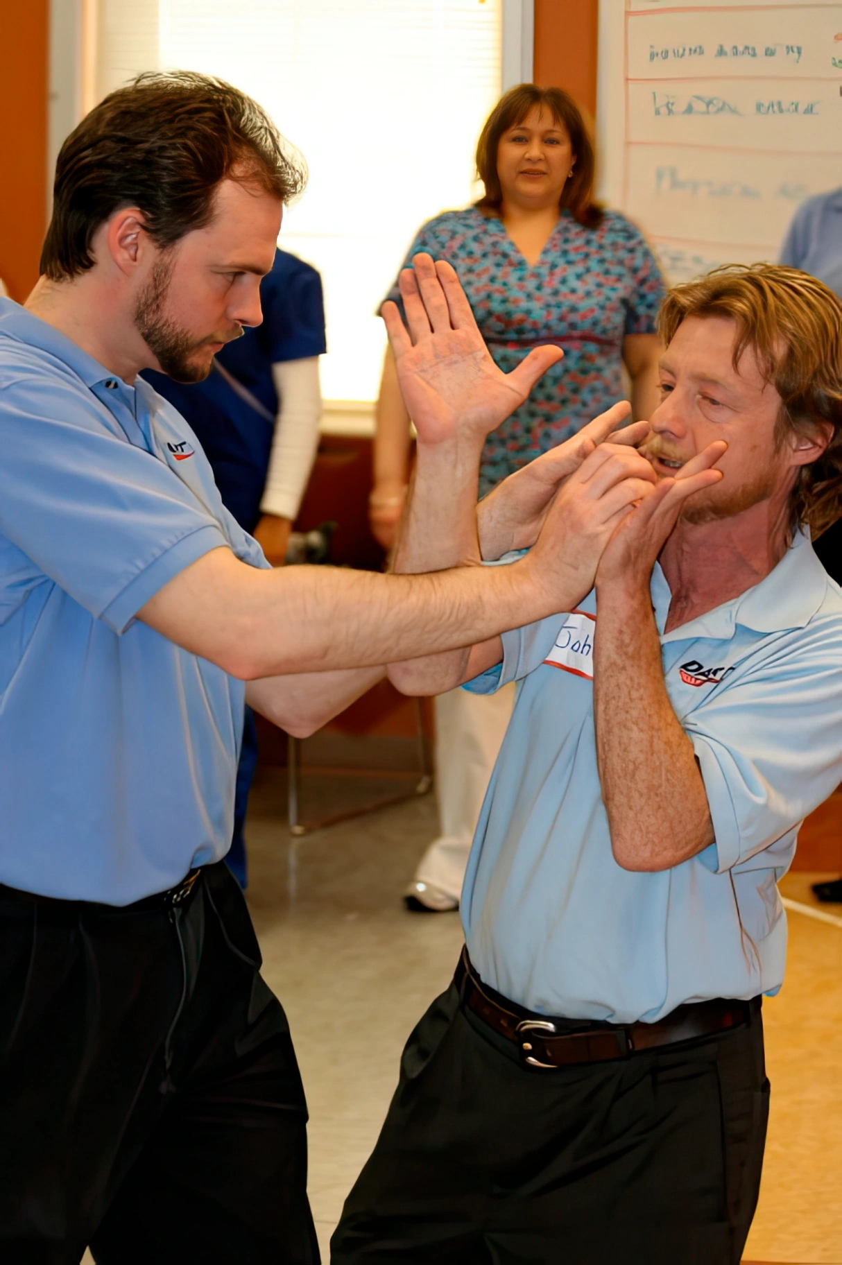 An instructor demonstrating a defensive technique during workplace safety training