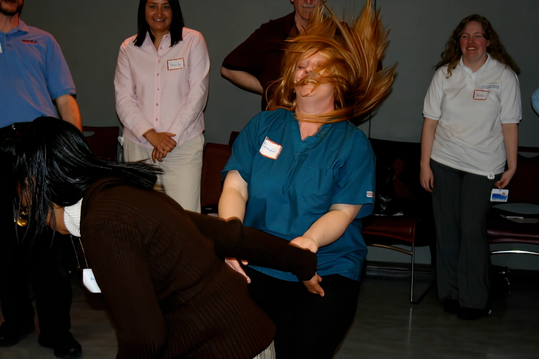 Participants practicing a physical response technique in a supervised training scenario